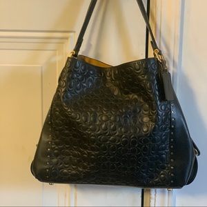 COACH Edie 31 black leather with embossed Signature C’s riveted shoulder bag.